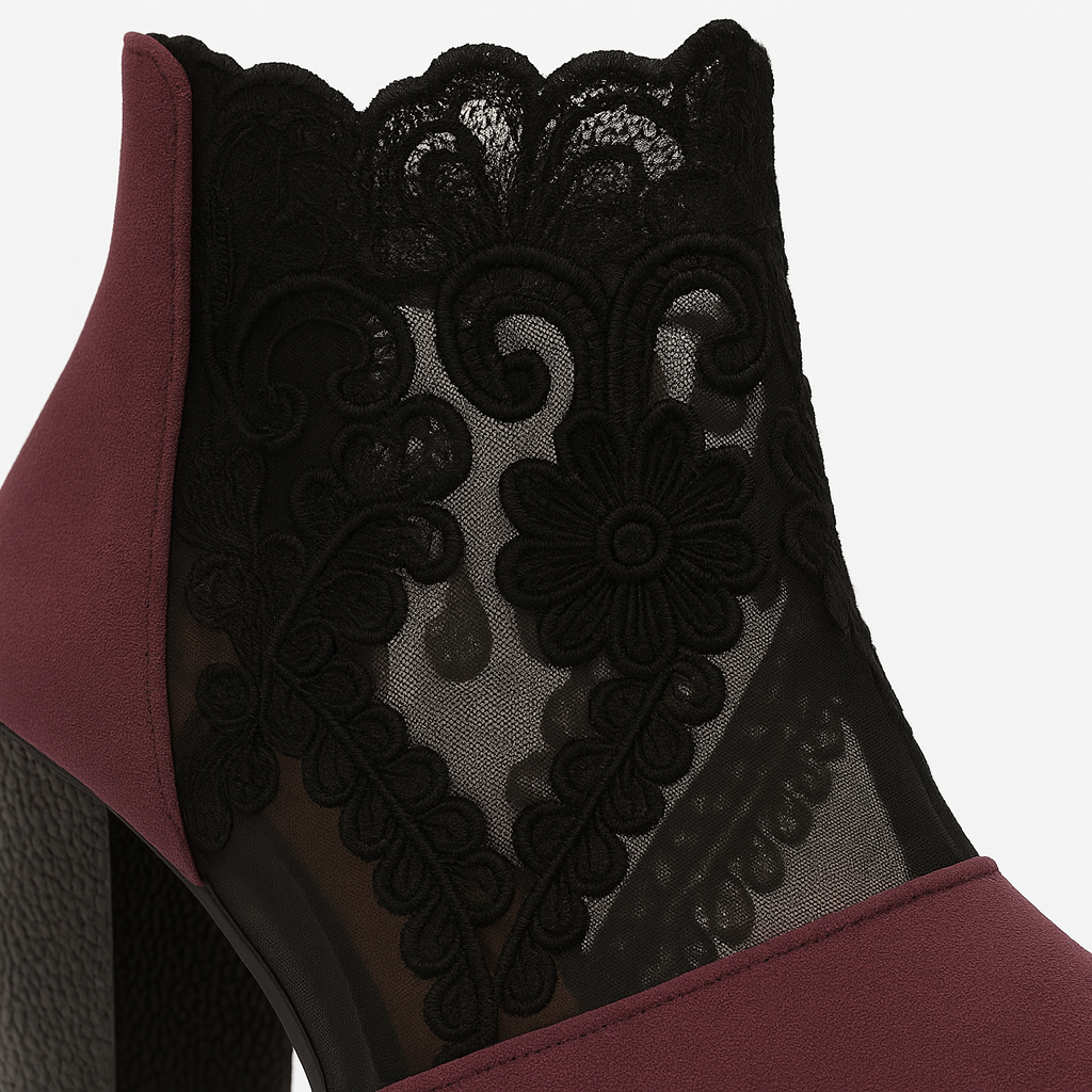 Heeled ankle boots with black embroidered lace panels and block heels.