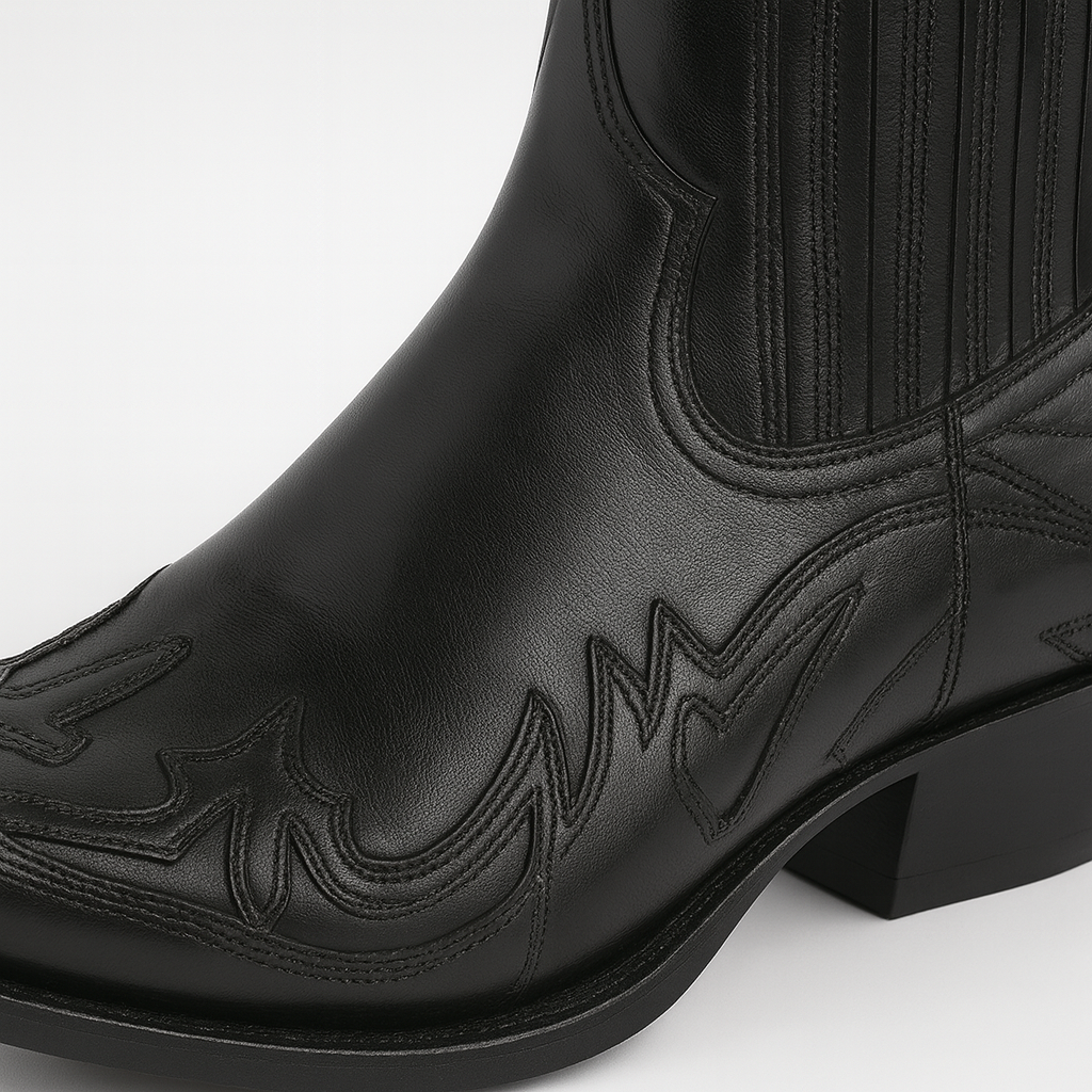 Western-style ankle boot with pointed toe, stitched detailing, and angled heel.