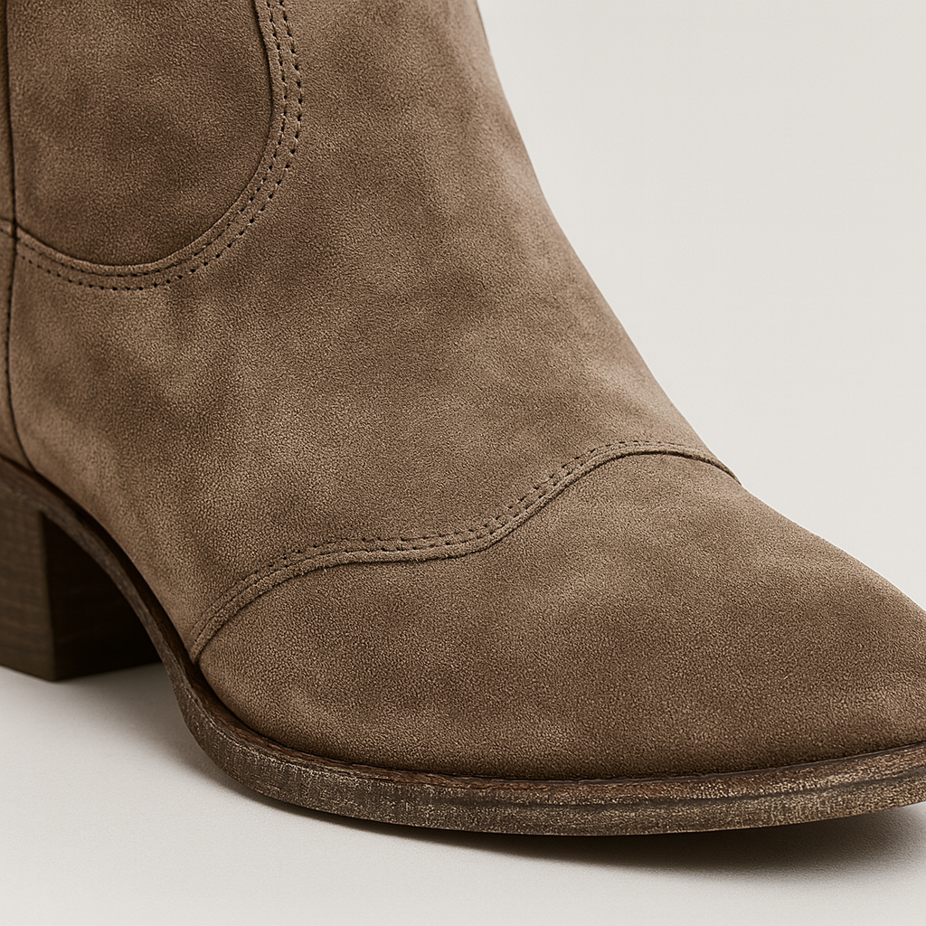 Suede Western-style ankle boots with curved topline and gently distressed soles.