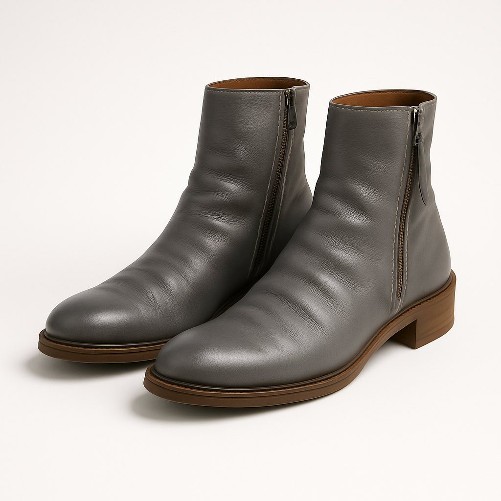 Distressed leather zip-up ankle boots with textured sole and rounded toe.